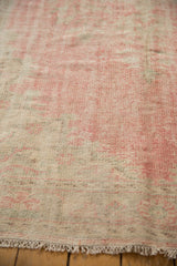 Distressed vintage Oushak rug showing low pile, foundation wear, and blush-beige tones.
