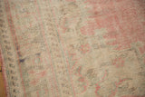 Softly worn vintage Oushak pile texture, blending blush, pink, and pale beige tones.