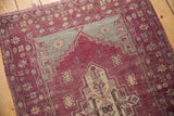Distressed vintage Oushak rug runner, a stepped aubergine and slate medallion with motifs.