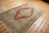 Distressed vintage Oushak rug with chestnut rust copper stepped medallion on silver ivory ground.