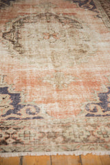 Distressed hand knotted Oushak pile reveals foundation, knot heads, dusty rose and denim blue.