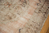Textural detail of distressed Oushak rug, showing antique ivory foundation and dusty rose knot heads.