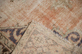 Vintage distressed Oushak carpet texture with low pile and visible hand knotted foundation.