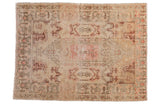 Distressed vintage Oushak rug, faded ivory lozenge medallion, blush rose Rococo plant motifs.
