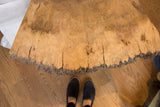 Live edge table showcasing natural wood burl, rough bark texture, and visible cracks.
