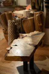 Detailed view of the natural live edge and rich wood grain on the side table.