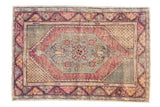Distressed vintage Oushak rug, slate blue diamond medallion, dusty wine red field, floral motifs.