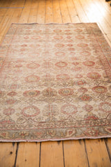 Distressed vintage Sivas rug border and field with sand, brick red floral motif, textured pile.