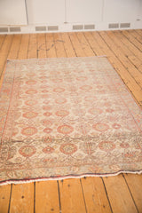 Vintage Distressed Sivas rug end with sand and brick red florals, wear, visible foundation.