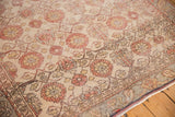 Distressed Sivas rug with muted allover floral pattern in sand, brick red, and blush.