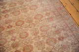 Close-up of distressed vintage Sivas rug, muted floral patterns and low pile texture.