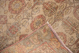 Distressed Sivas rug: worn sand and blush floral pile, exposed foundation, and fringed edge.