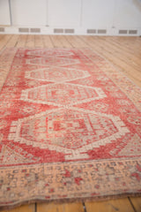 Distressed Turkish Oushak rug runner with raspberry red serrated medallions and even wear.