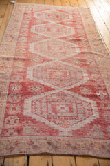 Distressed Oushak runner end, raspberry red and antique ivory patterned border.