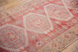 Distressed vintage Oushak runner with muted raspberry and ivory oversized serrated medallion pattern.