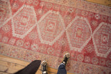 Distressed Oushak runner pile texture with raspberry red and antique ivory oversized medallions.