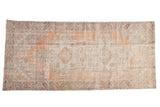 Distressed Oushak runner with faded tangerine, ivory, and silver geometric medallions, 3'9