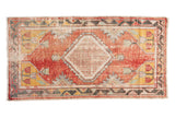 Vintage distressed Oushak runner with a diamond medallion, faded red, saffron yellow, and sea foam green.