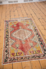 Vintage distressed Oushak runner with faded tomato red, saffron yellow, mostly even wear.