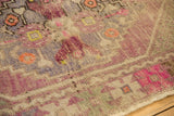 Textured pile of vintage Oushak rug, showing mauve, raspberry pink, and light foundation wear.