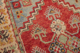 Low pile, knot heads on cherry red Oushak runner with floral border.