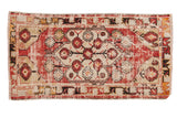 Distressed vintage Oushak runner with cherry red, beige floral medallion and vine border.