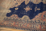 Distressed navy field, scalloped pale raspberry and ivory motifs on a vintage Sivas rug.