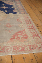 Abrashed silver field and pale raspberry floral motifs on a distressed Sivas rug.