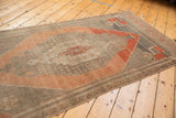 Distressed Oushak runner's overall texture, abrashes, and muted blush, silver, aubergine tones.