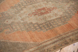 Distressed Oushak runner with faded blush rust, dusty aubergine, and ivory stepped medallion detail.