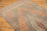 Distressed Oushak runner's worn pile, showing geometric patterns in blush rust, silver, aubergine, ivory.