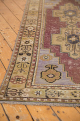 Distressed Oushak rug runner showing aubergine, sand, and lavender tones with worn motifs.