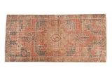 Vintage distressed Oushak runner with oversized medallion and floral border in rose, charcoal. 3'8