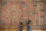 Decorative low pile and distressed texture of Oushak rug runner in dusty rose, charcoal.