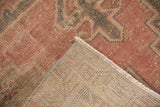 Distressed Oushak runner, dusty rose pile folded to reveal exposed knot heads and hand knotted foundation.