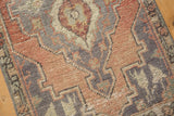 Distressed vintage Oushak rug pile with visible knot heads, featuring blush, red, silver, and ivory patterns.