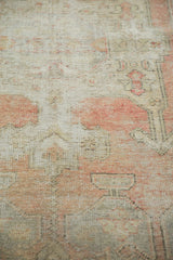 Textural detail of a vintage distressed Oushak rug showing exposed foundation in blush and sand.