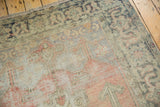 Vintage Distressed Oushak rug corner with distressed pile, time-softened blush, beige, and charcoal tones.
