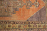 Distressed Oushak rug runner with stepped medallion and ornamental border details.