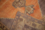 Distressed tangerine orange Oushak rug pile and folded hand-knotted back weave.