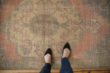 Faded blush, silver, and aqua tones on the worn pile of a vintage Turkish Oushak runner.