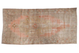 Distressed vintage Oushak runner displays oversized stepped medallion in pale blush, terracotta, beige, 4'9