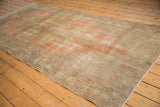 Vintage distressed Oushak runner showing stepped motifs and worn texture in blush and beige.
