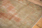 Distressed Oushak rug runner with even wear, exposed foundation, and pale blush tones.