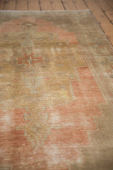 Distressed pile and abrash on the stepped motifs of this vintage Oushak runner.