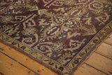 Distressed Oushak rug corner, aubergine field, rams horn vinery, faint foundation.