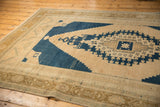 Worn pale bronze corner spandrel and navy blue field of the vintage Oushak rug.