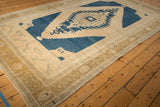 Distressed vintage Oushak rug's outer border, showing faded motifs in beige and bronze.