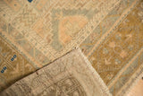 Distressed Oushak carpet's low pile texture, revealing faint foundation and muted geometric motifs.