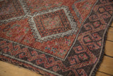 Distressed charcoal border with faded red, pink, and ivory motifs, showing even wear.